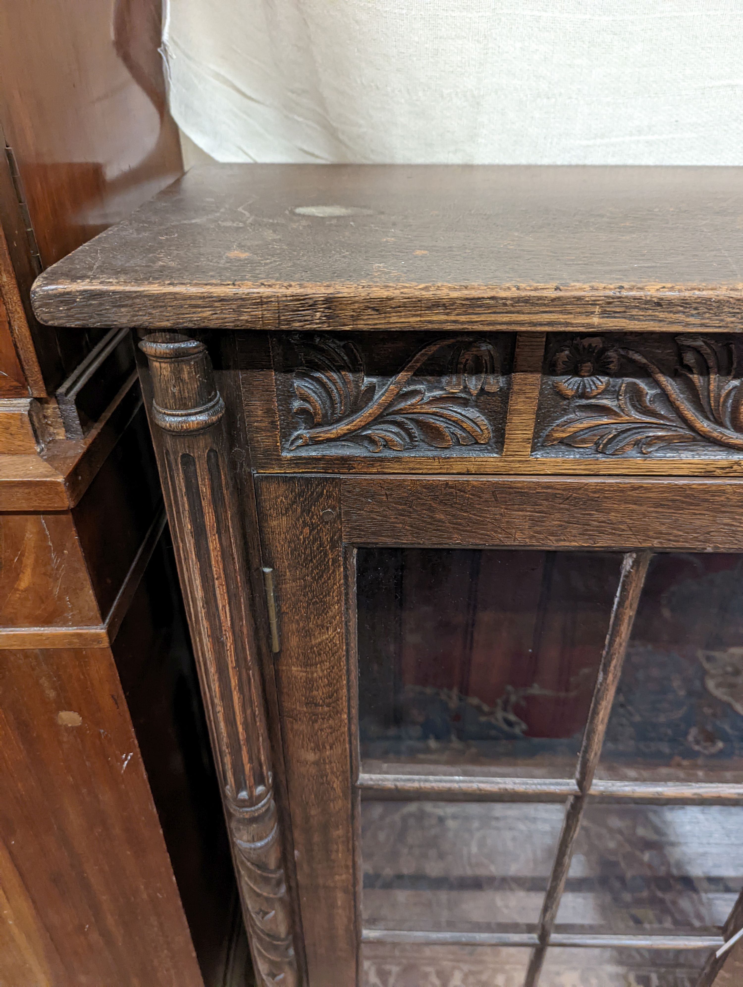 A 17th century style oak glazed low bookshelf. W-152cm, D-38cm, H-100cm.